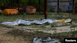 Обгоревшие тела погибших украинских военнопленных. Еленовка, Донецкая область, 29 июля 2022 года