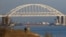 A Russian cargo ship is seen beneath a bridge connecting the Russian mainland with the Crimean Peninsula after three Ukrainian navy vessels were stopped by Russia from entering the Sea of Azov via the Kerch Strait in the Black Sea, Crimea November 25, 201