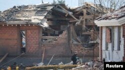 Эксперт-криминалист возле поврежденных зданий в Почхоне, Южная Корея, 6 марта 2025 года